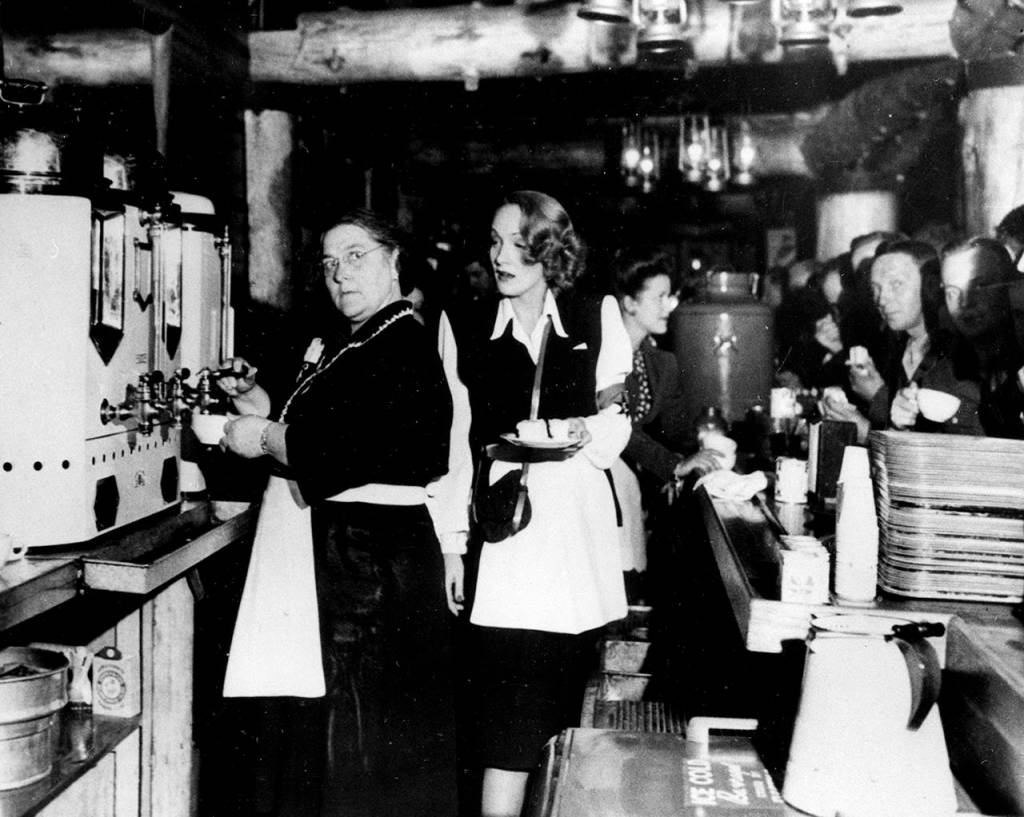 In this Feb. 9, 1944 photo, Alleta Sullivan (left), mother of the five Sullivan brothers who lost their lives in the sinking of the cruiser USS Juneau, works alongside actress Marlene Dietrich as they serve servicemen in the USO Hollywood Canteen in California. (AP Photo/File)
