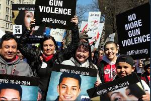 A group of about 20 people from the Tulalip Tribes, including three mothers of victims of the 2014 Marysville High School shooting, marched Saturday in Washington, D.C., to protest gun violence. Deborah Parker, a former vice chairwoman of the tribal board of directors, is holding up a sign. (Deborah Parker photo)