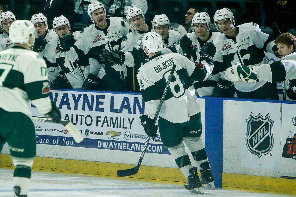 The Silvertips bench congratulates right wing Patrick Bajkov on a goal in the second period during the first game of an opening-round playoff series against the Thunderbirds on March 23, 2018, at Angel of the Winds Arena in Everett. (Ian Terry / The Herald)