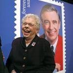 Joanne Rogers, Fred Rogers widow, shares a laugh with friends in front of a giant Mister Rogers Forever Stamp following the first-day-of-issue dedication in WQEDs Fred Rogers Studio in Pittsburgh on Friday. (Gene J. Puskar / Associated Press)