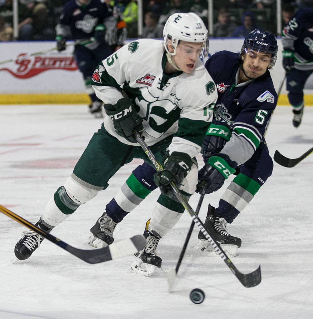 Everetts Sean Richards fends off Seattles Jarret Tyszka in the first period of a playoff game on March 24, 2018, at Angel of the Winds Arena in Everett. (Kevin Clark / The Herald)