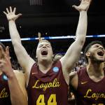 Loyola-Chicagos Lucas Williamson (left), Nick Dinardi (center) and Christian Negron celebrate winning an NCAA Tournmanet Elite Eight game against Kansas State on March 24, 2018, in Atlanta. (AP Photo/David Goldman)