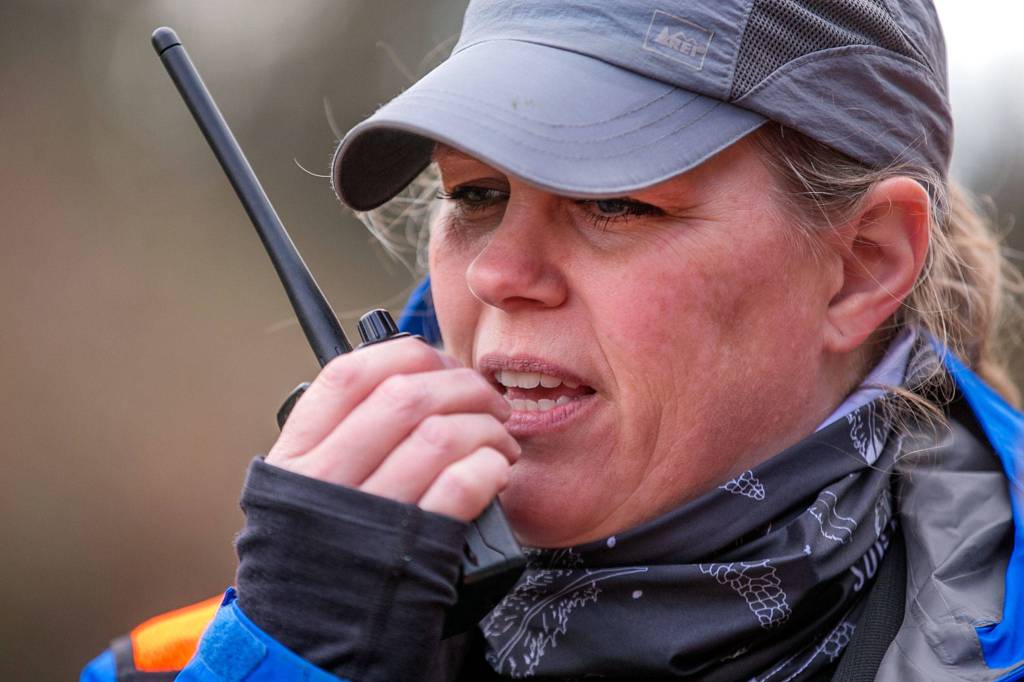 Wendy Bowlin makes a radio check during the search. (Kevin Clark / The Daily Herald)