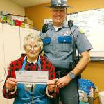 Washington State Patrol Trooper Brian Zillmer presents his donation to JoAnn Sewell of the Marysville Community Food Bank. (Contributed photo)