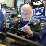 Trader Kevin Walsh works on the floor of the New York Stock Exchange on Monday. U.S. stocks rose sharply in early trading as the market made up some of its huge losses from last week. (AP Photo/Richard Drew)