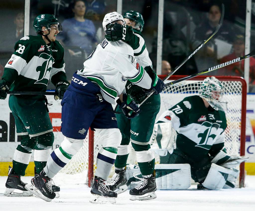 Everetts Sean Richards (center) gets a glove in the face of Seattles Austin Strand on Tuesday during a playoff game at ShoWare Arena in Kent. (Ian Terry / The Herald)