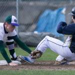 Edmonds-Woodways Gunnar Whitelaw tags out Arlingtons Dylan Corporon Wednesday at Arlington High School. (Kevin Clark / The Herald)
