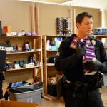 Officers unloaded suspected stolen goods off the shelves of a gold-buying business Friday north of Lynnwood. (Caleb Hutton / Herald)