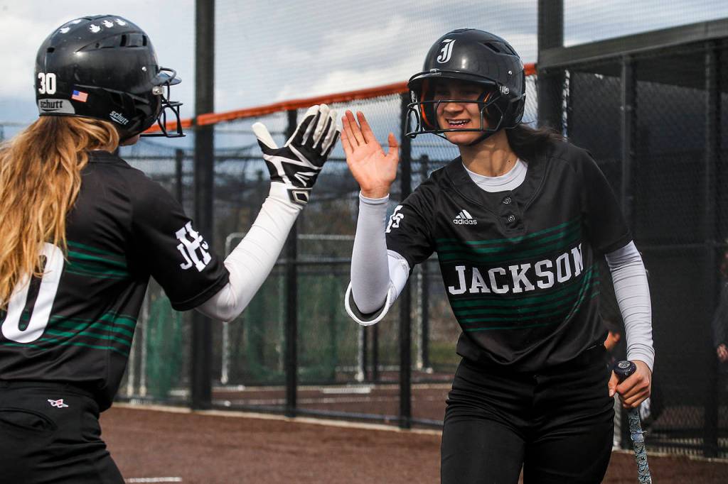 Jacksons Braylin Jenson (right) is congratulated by teammate Sam Mutolo after scoring during a game against Monroe on March 30, 2018, at Monroe High School. (Ian Terry / The Herald)