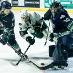 Everett right wing Garrett Pilon (center) seeks out a loose puck as Seattle goaltender Liam Hughes (right) and Jaxan Kaluski (left) defend during a playoff game at Angel of the Winds Arena in Everett on Saturday, March 31. (Ian Terry / The Herald)