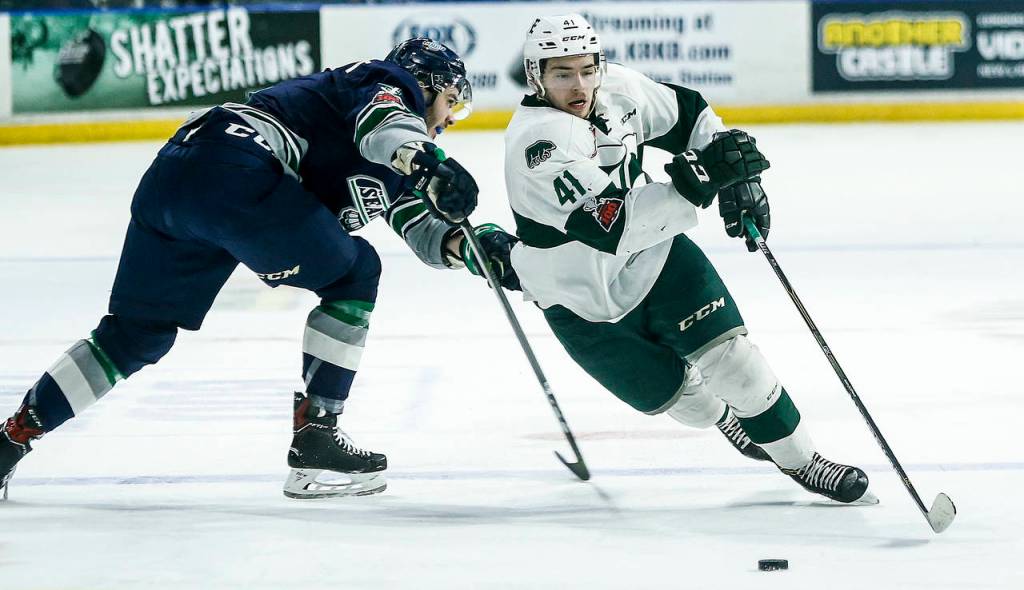 Everett forward Garrett Pilon (right) skates past Seattle defenseman Turner Ottenbreit (left) during a playoff game at Angel of the Winds Arena in Everett on Saturday, March 31. (Ian Terry / The Herald)
