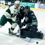 Silvertips right wing Patrick Bajkov (8) battles in front of the net as Seattle goaltender Liam Hughes (30) looks for the puck during a playoff game at Angel of the Winds Arena in Everett on Saturday, March 31. (Ian Terry / The Herald)