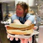 Tammy Ohrmund displays a bacon sausage hot dog that is sold on the ferries. (Kevin Clark / The Herald)