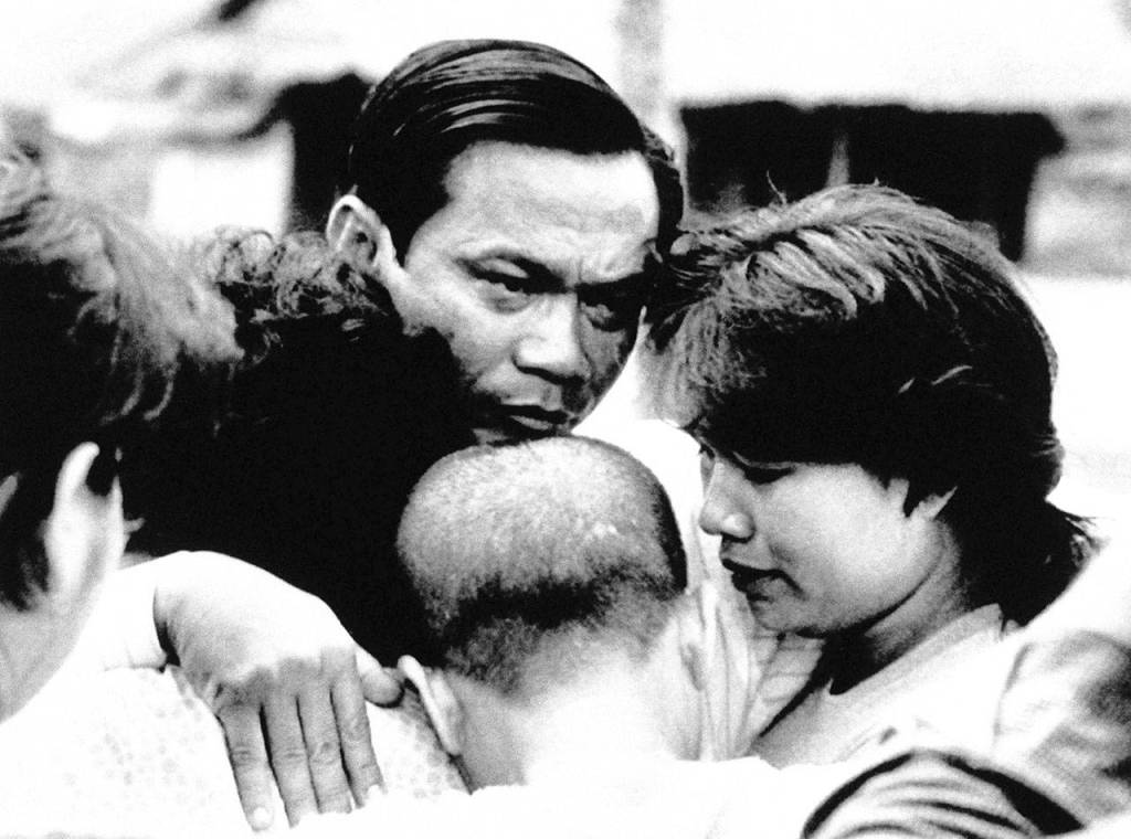 Dith Pran (center) embraces relatives he had not seen since 1979 at a refugee camp in Thailand on Aug. 16, 1989.(AP Photo/Gray, file)