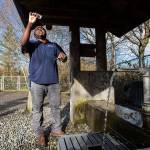 Alderwood Water & Wastewater District water quality tech assistant Matt Williams looks at the clarity of a water sample taken from the artesian well located along 164th Street in Lynnwood. The well, also known as Well No. 5 or the 164th Street Artesian Well, is more than 400 feet deep and flows at a rate of about 10 gallons per minute. (Andy Bronson / The Herald)
