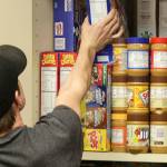 Jensen Webster sorts through food stuffs at the Sultan High School in Sultan on March 14, 2018. (Kevin Clark / The Daily Herald)