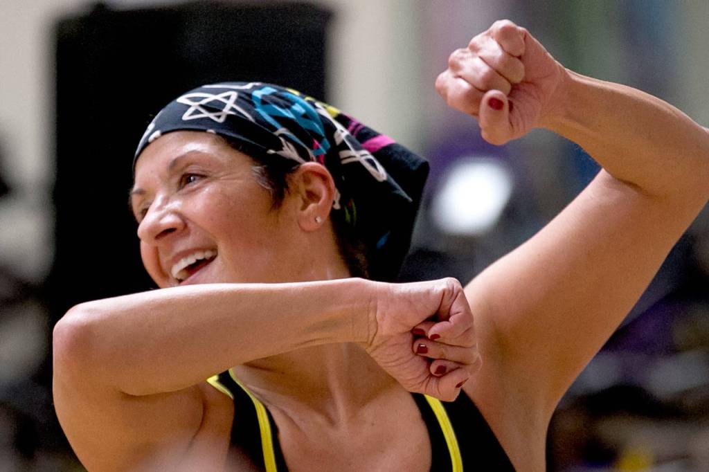 Nancy Isely leads her Spanish Zumba class Monday night at the YMCA in Mukilteo. (Kevin Clark / The Herald)