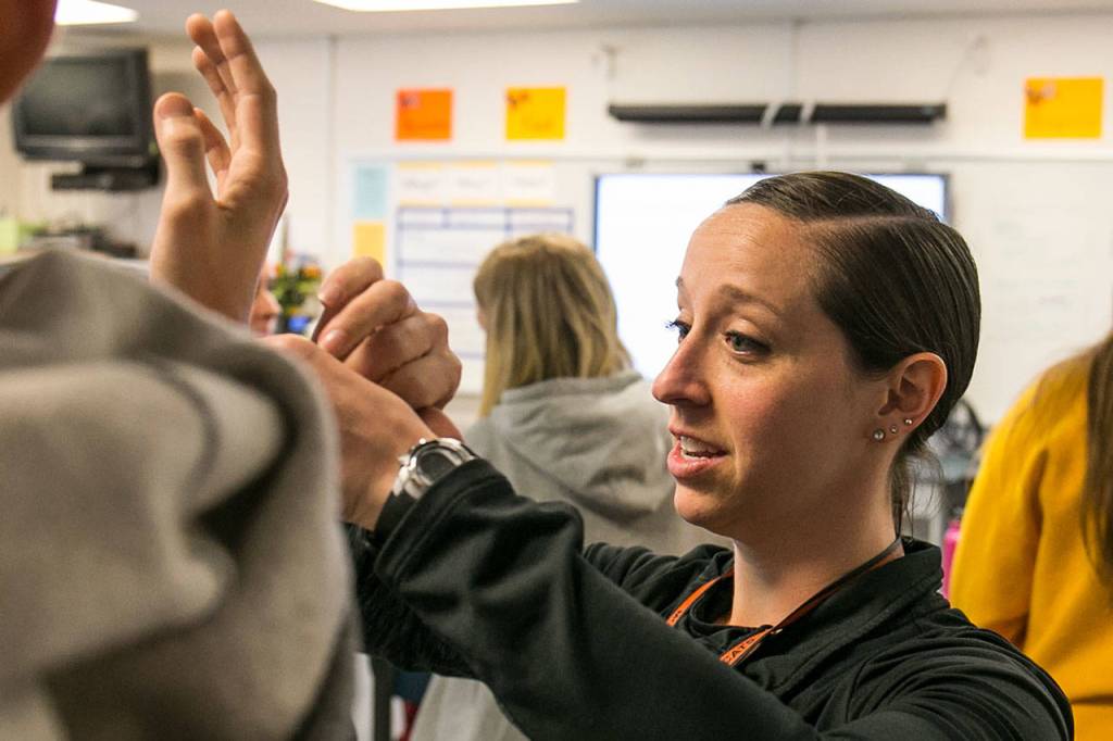 Heather Sevier demonstrates the proper technique in her advanced sports medicine class Monday afternoon at Monroe High School. (Kevin Clark / The Herald)