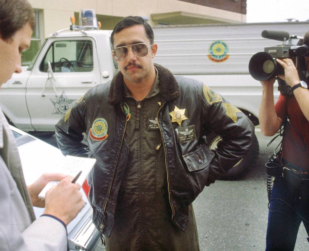 An undated photo shows John Taylor wearing his jacket, which has Snohomish County Sheriff and Search & Rescue patches. (Herald file)
