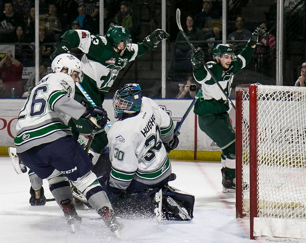 Everetts Connor Dewar (left) and Everetts Kevin Davis celebrate a goal with Seattles Nolan Volcan and Seattles Liam Hughes (30) at The accesso ShoWare Center in Kent on March 30. (Kevin Clark / The Daily Herald)