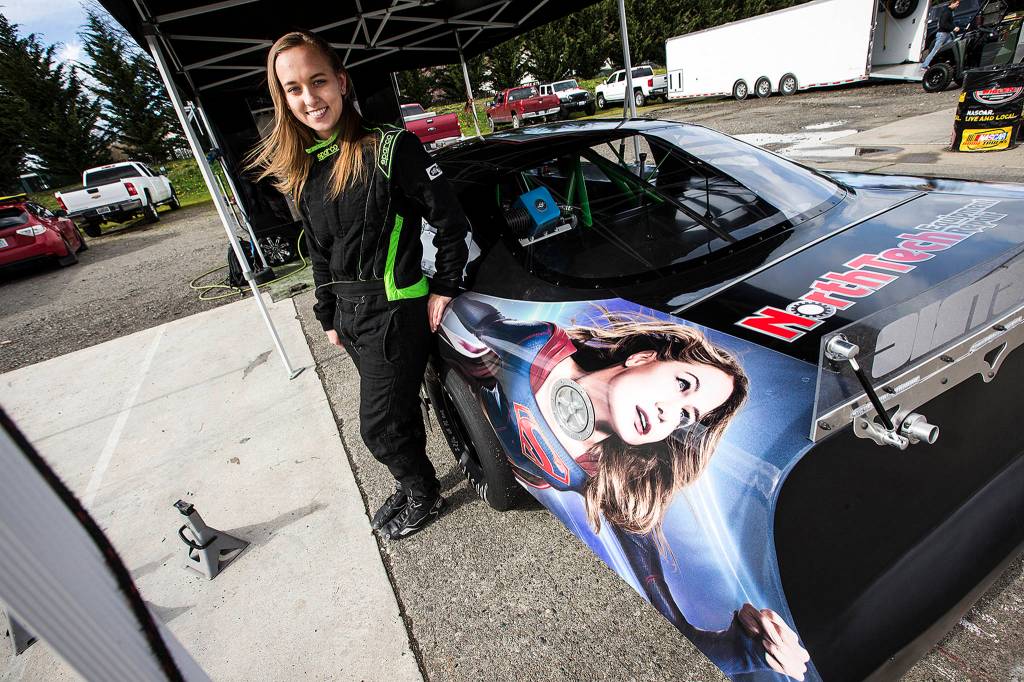 Brittney Zamora stands next to her Supergirl Super Late Model race car at the Evergreen Speedway on March 24. (Ian Terry / The Herald)