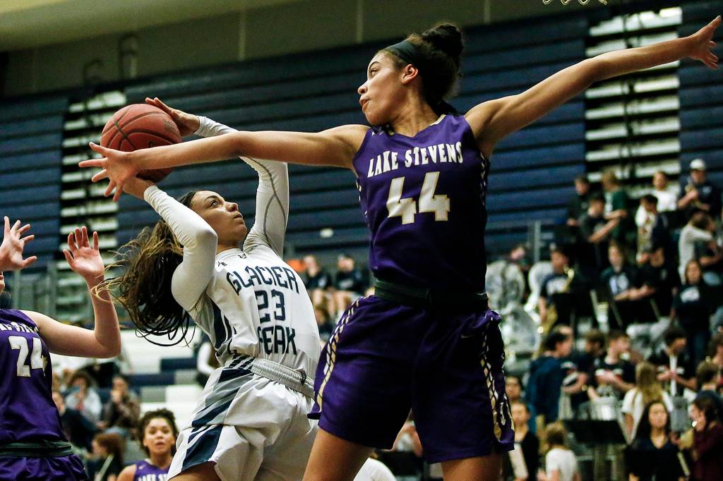 Glacier Peaks Alexyss Newman (23) takes a shot as shes guarded by Lake Stevens Kylee Griffen (44) during a game at Glacier Peak High School in Snohomish on Jan. 19. (Ian Terry / The Herald)