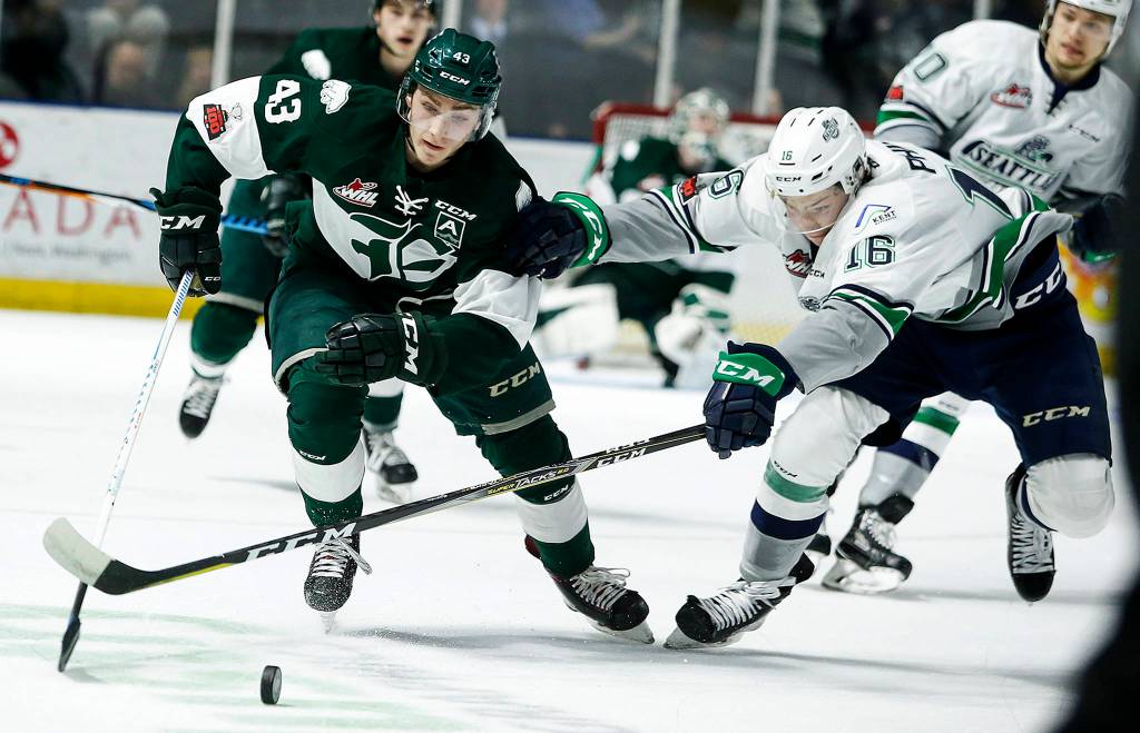 Silvertips center Connor Dewar (left) battles for the puck with Seattles Noah Philp during a playoff game at Showare Arena in Kent on March 27. (Ian Terry / The Herald)