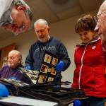Nothing like getting a bunch of historians and history buffs together to look at scrapbooks and old photo albums. From left, Allan White, Dave Ramstad, Jack ODonnell, Janice White and Jerry Solie do just that Tuesday night at the Everett Public Library. (Dan Bates / The Herald)
