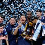 Villanova players celebrate with the national championship trophy after beating Michigan 79-62 in the NCAA Tournament title game on Monday in San Antonio. (AP Photo/David J. Phillip)