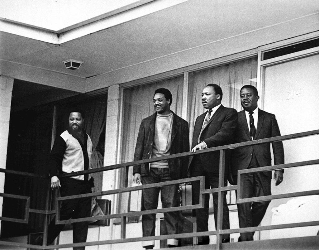 In this April 3, 1968 photo, the Rev. Martin Luther King Jr. stands with other civil rights leaders on the balcony of the Lorraine Motel in Memphis, Tennesee, a day before he was assassinated at approximately the same place. From left are Hosea Williams, Jesse Jackson, King, and Ralph Abernathy. (AP Photo/Charles Kelly, File)
