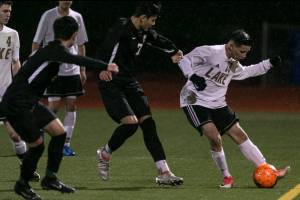 Lake Stevens Victor Vega control the ball with Jackson giving chase at Lake Stevens High School Wednesday night in Lake Stevens on April 4, 2018. (Kevin Clark / The Daily Herald)