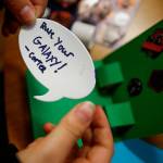 Carter Howell prepares to stick his message on a pop-up card to be sent to the nonprofit Cards for Hospitalized Kids. (Dan Bates / The Herald)