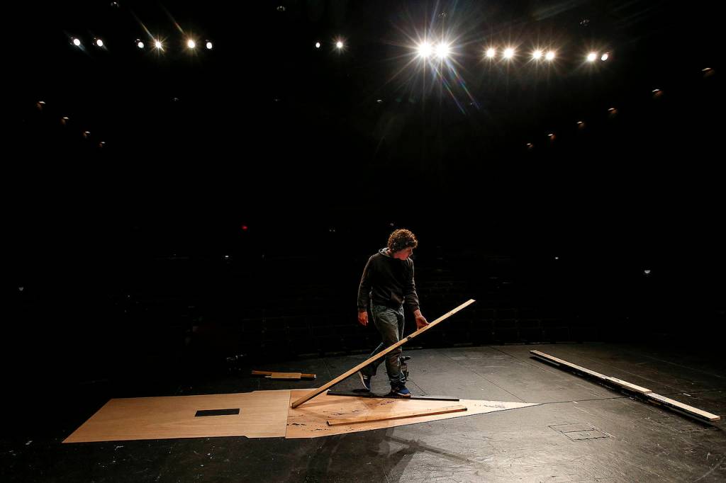 The framework for a castle tower is laid out by a student on the prop-building crew. (Ian Terry / The Herald)