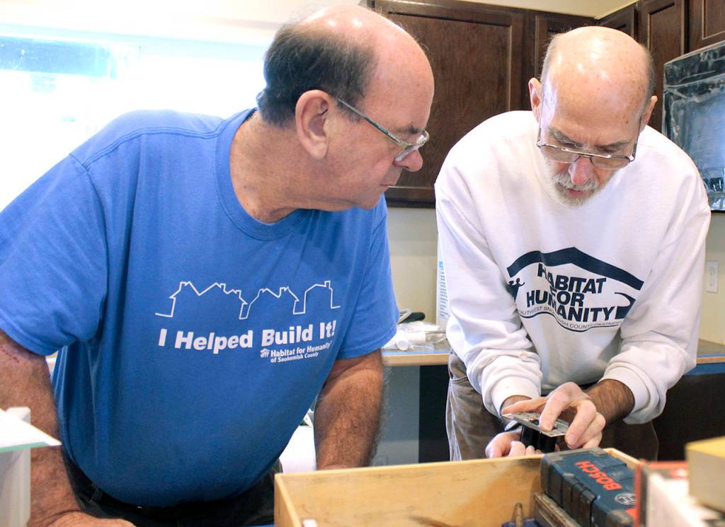 Bill Seufer (left) and Bob Gardner install counters at a Habitat home in Everett. (Habitat for Humanity of Snohomish County)