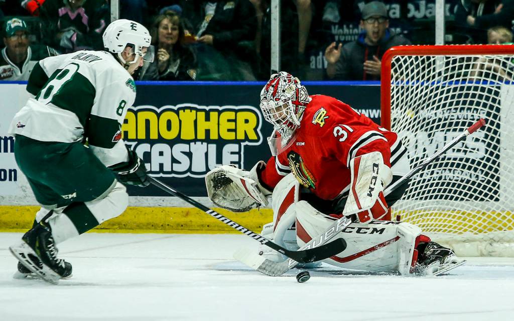 Silvertips right wing Patrick Bajkov (left) moves the puck past Portland goalie Cole Kehler for a goal in the first period of a second round playoff game at Angel of the Winds Arena in Everett on Saturday, April 7. (Ian Terry / The Herald)