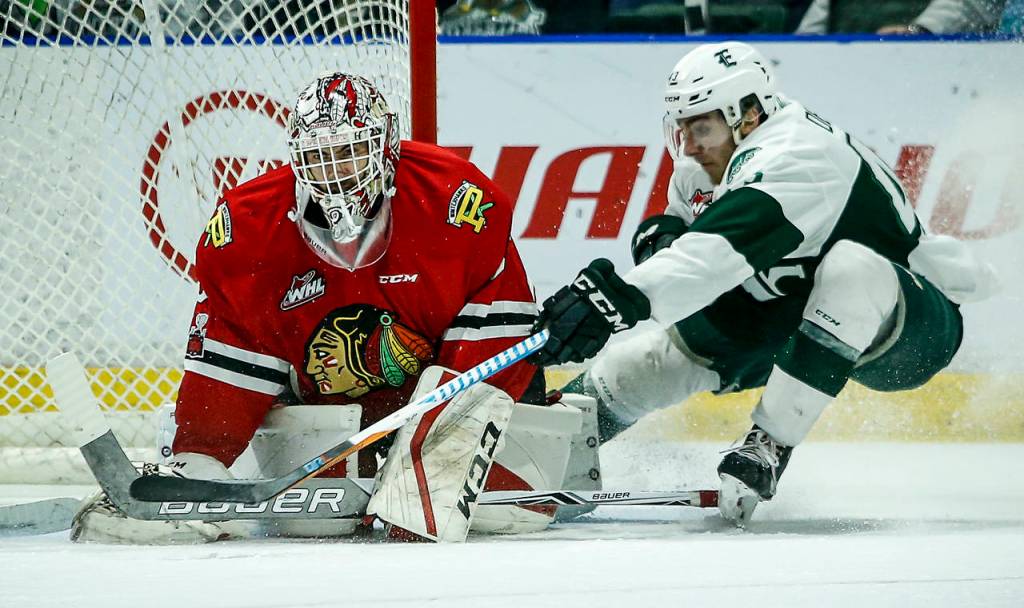 Silvertips center Connor Dewar (right) pressures Portland goaltender Cole Kehler during a second round playoff game at Angel of the Winds Arena in Everett on Saturday, April 7. (Ian Terry / The Herald)