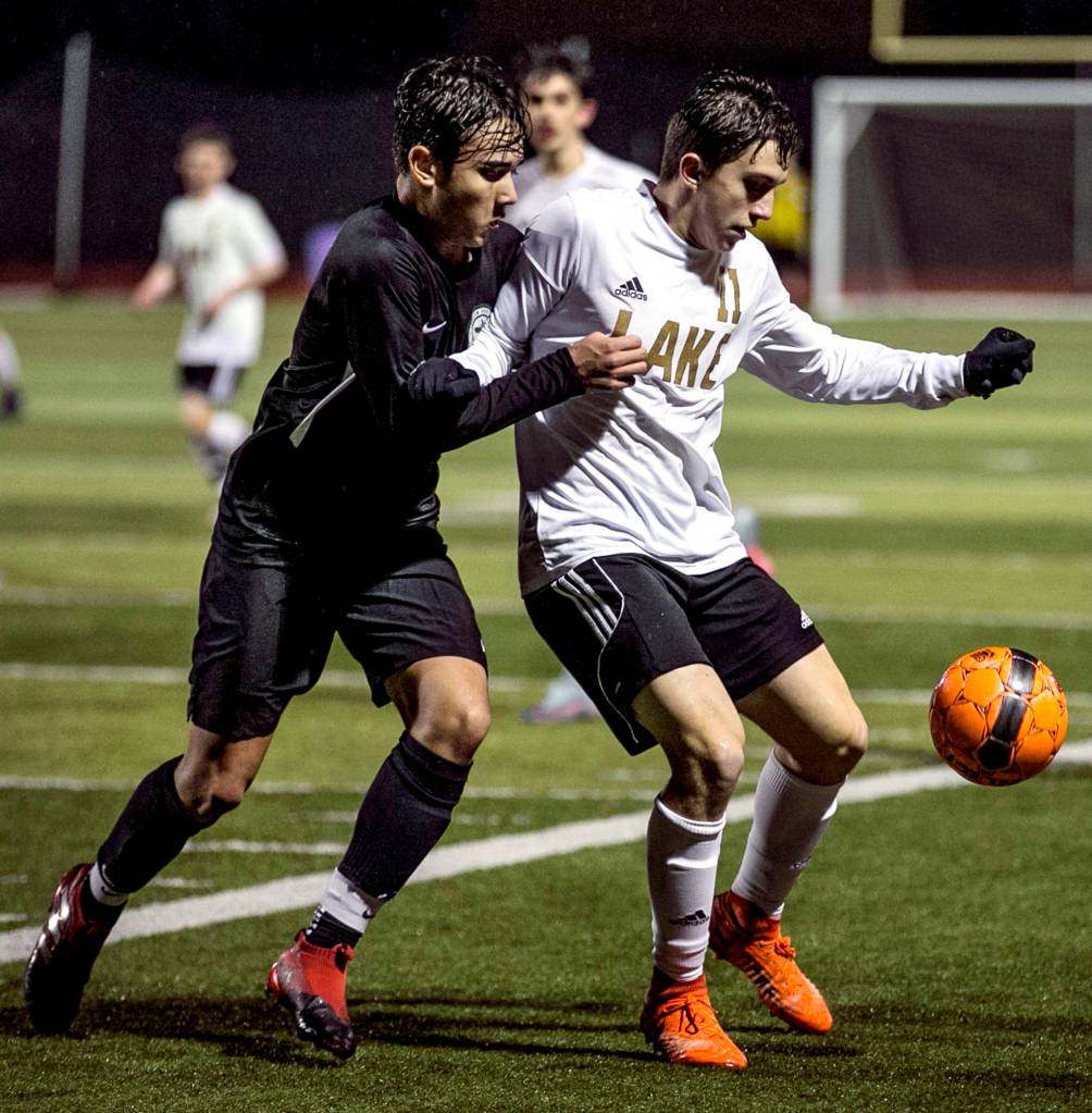 Lake Stevens Ethan Anastasi keeps the ball from Jacksons Oli Giessler at Lake Stevens High School on April 4. (Kevin Clark / The Herald)