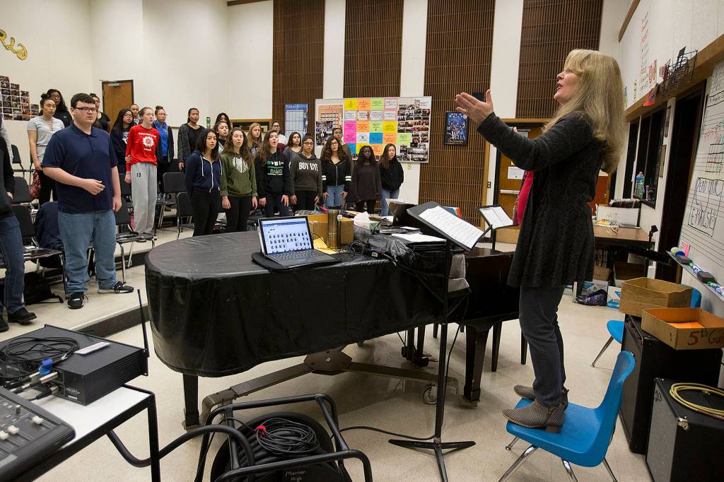 Choir director Patricia Schmidt (right) leads a rehearsal for the Mariner High School chamber choir at school on March 29. (Ian Terry / The Herald)