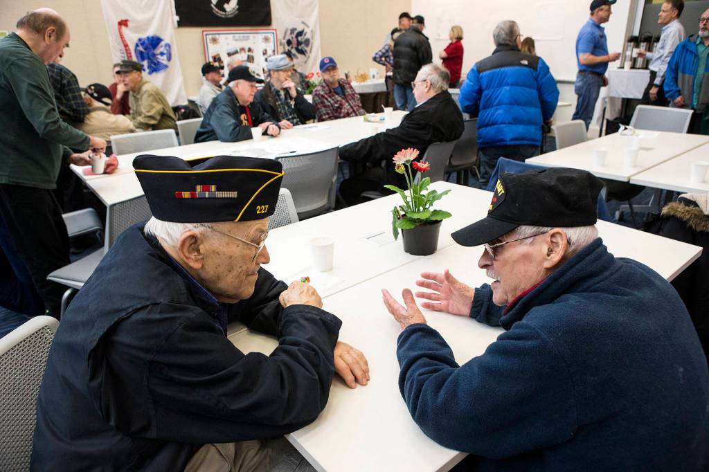 World War II Navy veteran Terry Luck (left) talks with Korean War Army veteran Philip Sacks during The Heros Cafe in Lynnwood, an informal monthly gathering for veterans, in the Verdant Community Wellness Center on March 27. (Andy Bronson / The Herald)