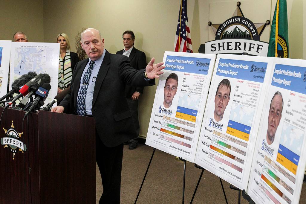 Snohomish County cold case detective Jim Scharf (left) presents new images of a potential suspect in the unsolved 1987 murder of Jay Cook and Tanya Van Cuylenborg during a news conference in Everett on Wednesday. (Ian Terry / The Herald)