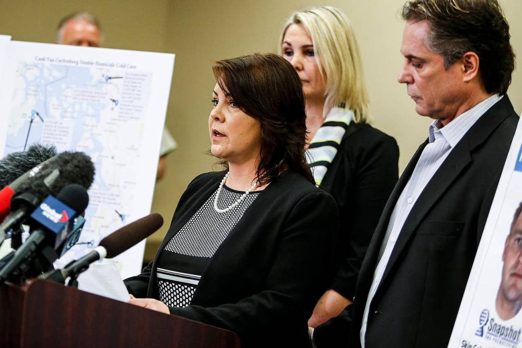 Laura Baanstra (center), a sister of 1987 homicide victim Jay Cook, speaks at a news conference in Everett on Wednesday. (Ian Terry / The Herald)
