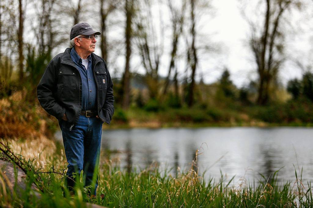 Last year, Reiner suffered a heart attack not far from the idylic pond (background) that he created on his farm along the Skykomish River at Monroe. He survived and is doing well, but he and his wife Charlene have chosen to sell the farm in a way that will protect it from future development. The farm has been in the family for more than 100 years. (Dan Bates / The Herald)