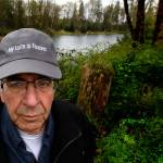 Last year, Reiner suffered a heart attack not far from the idylic pond (background) that he created on his farm along the Skykomish River at Monroe. He survived and is doing well, but he and his wife Charlene have chosen to sell the farm in a way that will protect it from future development. The farm has been in the family for more than 100 years. (Dan Bates / The Herald)