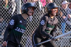 Jacksons Braylin Jenson (left) and Jessica Asantor celebrate the winning run against Lake Stevens at Henry M. Jackson High School Tuesday afternoon in Mill Creek on April 10, 2018. Jackson won 2-1 in extra innings. (Kevin Clark / The Daily Herald)