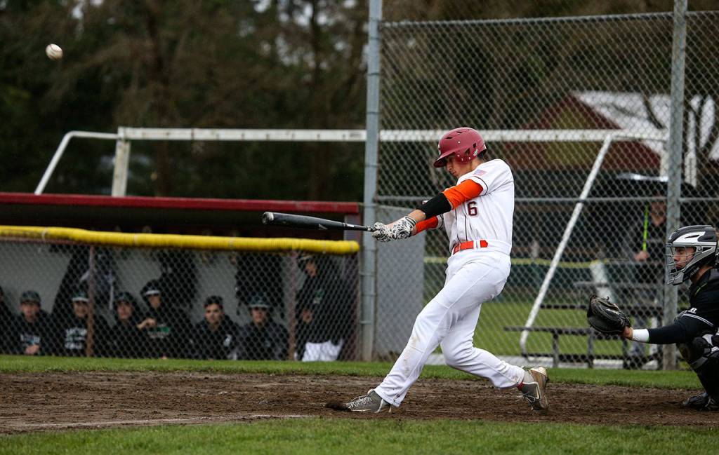 Cascades Brock Gillis hits a two-run triple in the first inning of a game against Jackson on April 11, 2018, at Cascade High School in Everett. (Andy Bronson / The Herald)