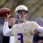 University of Washington quarterback Jake Browning looks to pass at during a March 28 practice in Seattle. (AP Photo/Elaine Thompson)