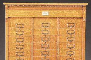This antique filing cabinet has 48 drawers for lateral files