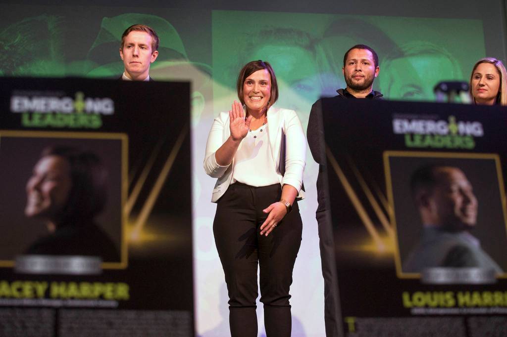 Lacey Harper waves to her family after being named the Herald Business Journals Emerging Leader in a gala at the Marysville Opera House. on Thursday, April 12 in Marysville. Full story <a href="http://www.heraldnet.com/business/she-helped-traumatized-people-get-through-two-big-tragedies/" target="_blank">here</a>. (Andy Bronson / The Herald)