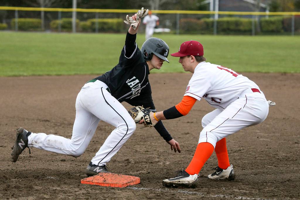 Jacksons Mason Coe avoids the tag at third base by Cascades Jacob Sesso as Cascade High hosted Jackson in a baseball game on April 11 in Everett. (Andy Bronson / The Herald)