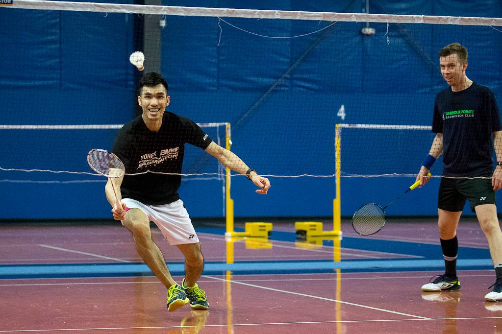 Chris Lee (left) and Daniel Tumason play badminton at Harbour Pointe Badminton Club in Mukilteo on April 8. (Ian Terry / The Herald)